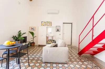 a living room with a chair and a table at A casa di Simona in Palermo