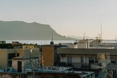 a view of roofs of buildings and a body of water at Casa Vacanza Stella Maris in Isola delle Femmine
