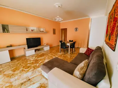 a living room with a couch and a table at Casa Vacanza Stella Maris in Isola delle Femmine