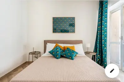 a large bed with yellow pillows in a room at La Dimora dei Teatri, Luxury rooms in Palermo