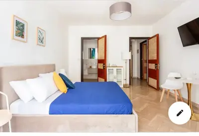 a small room with a bed and a table and a tv at La Dimora dei Teatri, Luxury rooms in Palermo