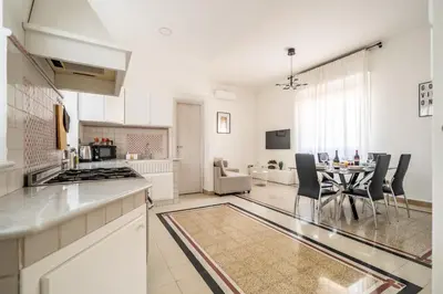 a kitchen and living room with a table and chairs at [La Maiolica] - Centro storico in Palermo