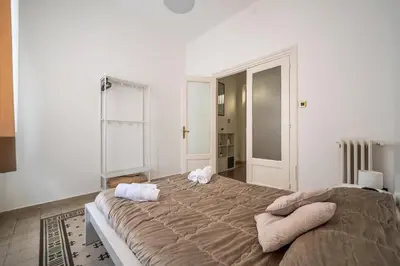 a bedroom with a large bed with towels on it at [La Maiolica] - Centro storico in Palermo