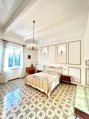 a bedroom with a bed and a chandelier at Sunny Home in Palermo