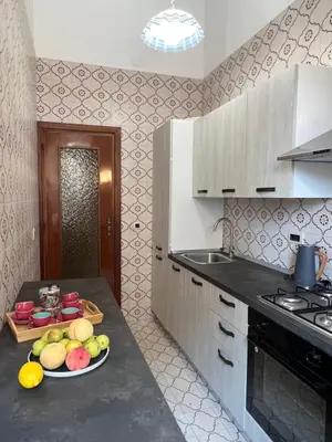 a kitchen with a plate of fruit on a counter at Sunny Home in Palermo