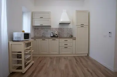 a kitchen with white cabinets and a microwave at Terre d'oro, appartamento di lusso in centro città in Palermo