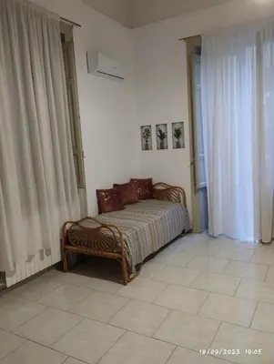 a bedroom with a bed in the corner of a room at La casa di Nanà in centro in Palermo