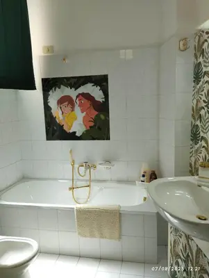 a white bathroom with a tub and a sink at La casa di Nanà in centro in Palermo