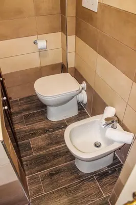 a bathroom with a toilet and a sink at Alexander House in Palermo