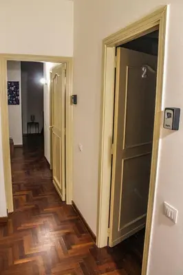 a hallway with two doors and a wooden floor at Alexander House in Palermo