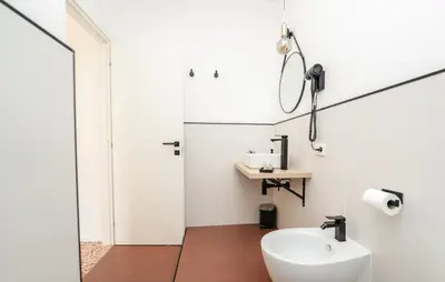 a white bathroom with a sink and a mirror at Valguarnera Studio Apartments in Palermo