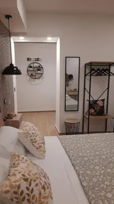 a bedroom with a bed and two mirrors on the wall at Garden Suite Apartment in Palermo