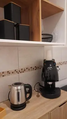 a kitchen counter with a coffee maker and a tea kettle at Garden Suite Apartment in Palermo