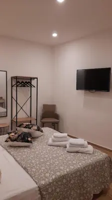 a bedroom with a bed with three towels on it at Garden Suite Apartment in Palermo