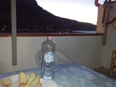 a bottle of water sitting on a table with bananas at Casa Vacanza Terrazza sul Mare in Castellammare del Golfo
