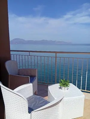a balcony with a table and chairs and the ocean at Finestra sul Mare di Alessandro in Balestrate