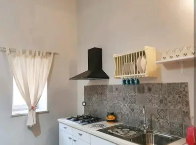 a kitchen with a sink and a stove top oven at Ally's house in Palermo