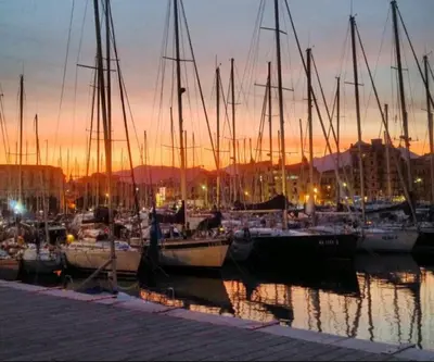 a group of boats docked in a harbor at sunset at Ally's house in Palermo
