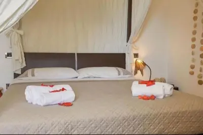 a bedroom with a large bed with towels on it at Villa Costantino in Trappeto