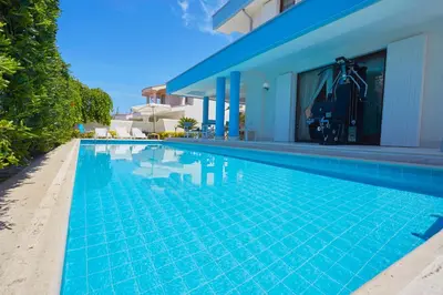 a swimming pool in front of a villa at Villa Costantino in Trappeto