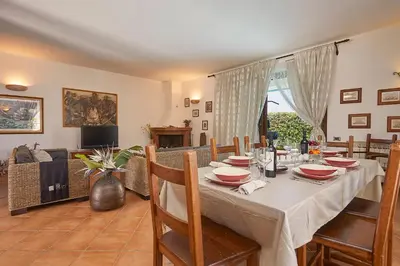 a dining room with a table and a couch at Villa Costantino in Trappeto