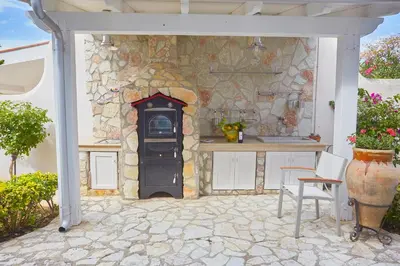 a kitchen with a stove in a stone wall at Villa Costantino in Trappeto