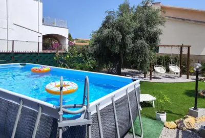 a swimming pool with a pool noodle in a backyard at Anastasia's House in Trabia