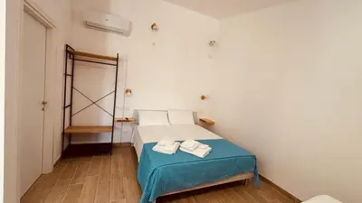a bedroom with a bed with two towels on it at L'angolo in centro in Partinico