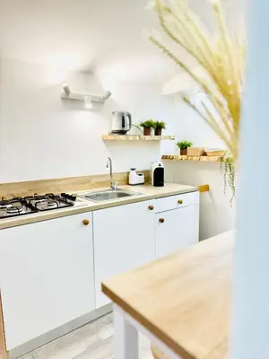 a kitchen with white cabinets and a sink at Centro Storico Palermo Stationsuite N5 WiFi Tutto a Piedi! in Palermo