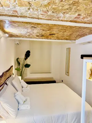 a bedroom with a white bed with a stone ceiling at Centro Storico Palermo Stationsuite N5 WiFi Tutto a Piedi! in Palermo