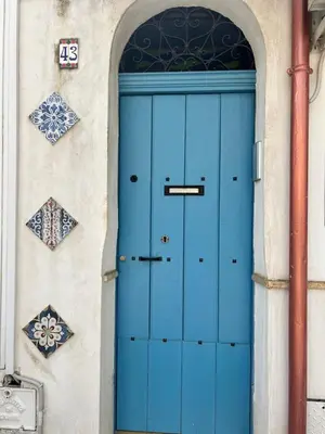 a blue door on a building with tiles on it at PortAzzurra in Carini