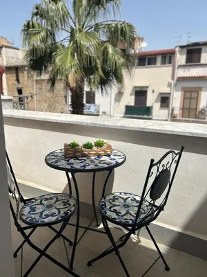 a table and two chairs on a balcony at PortAzzurra in Carini
