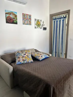 a bedroom with a bed with two pillows on it at PortAzzurra in Carini