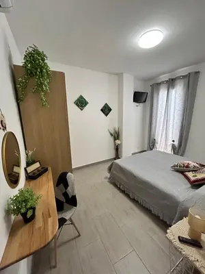 a bedroom with a bed and a table with a mirror at PortAzzurra in Carini