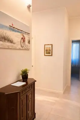 a room with a desk and a painting on the wall at Giardino Lussemburgo, Elegante e confortevole appartamento tra Mondello e il centro storico di Palermo in Palermo