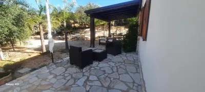 a stone walkway with a pavilion next to a building at Al ficodindia in Scopello