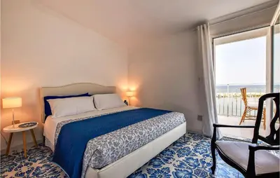 a bedroom with a bed and a window and a chair at Amazing Home In Trappeto With Wifi in Trappeto