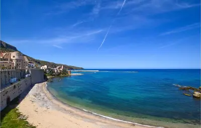 a view of a beach with blue water and buildings at Amazing Home In Trappeto With Wifi in Trappeto