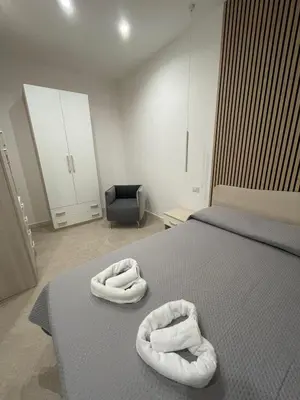 two towels sitting on a bed in a bedroom at Casa vacanze Soraja in Palermo