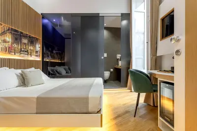 a hotel room with a bed and a bathroom at Hibrido in Palermo