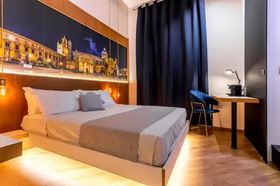 a hotel room with a bed and a desk at Hibrido in Palermo