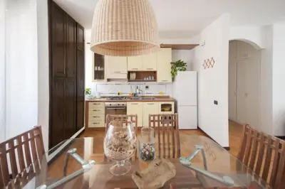 a kitchen with a glass table with a vase on it at Casa Sul Mare Seaside apt in front of the sea in Palermo