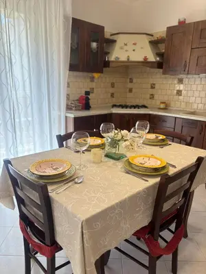 a table with wine glasses on it in a kitchen at Casa Vacanze Gloria in Balestrate