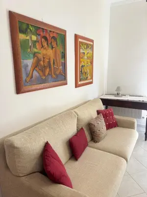 a couch in a living room with a painting on the wall at Casa Vacanze Gloria in Balestrate