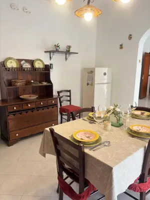 a dining room with a table with plates on it at Casa Vacanze Gloria in Balestrate
