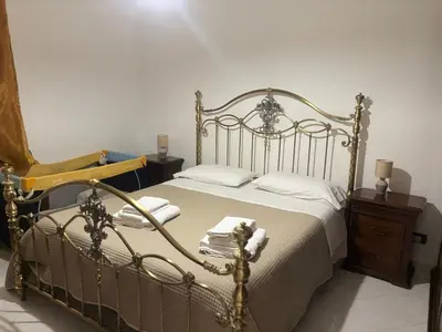 a bedroom with a bed and a wooden dresser at Casa Vacanze Gloria in Balestrate