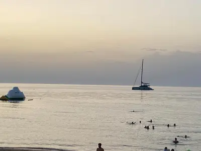 a group of people in the water with a sail boat at Casa Vacanze Gloria in Balestrate