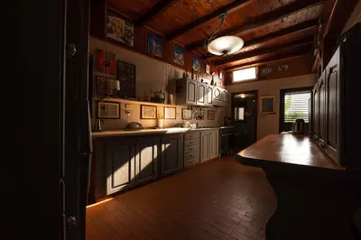 a large kitchen with white cabinets and a wooden ceiling at Bella Vista Sant Orsula 2 bedroom View Terrace Historic Center Spacious Apartment in Termini Imerese