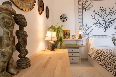 a bedroom with a bed and a table with a lamp at Bella Vista Sant Orsula 2 bedroom View Terrace Historic Center Spacious Apartment in Termini Imerese