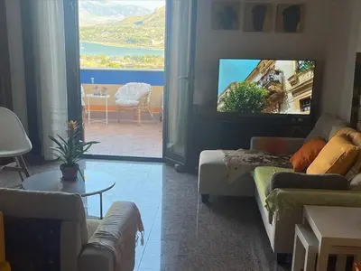 a living room with a couch and a flat screen tv at Bella Vista Sant Orsula 2 bedroom View Terrace Historic Center Spacious Apartment in Termini Imerese